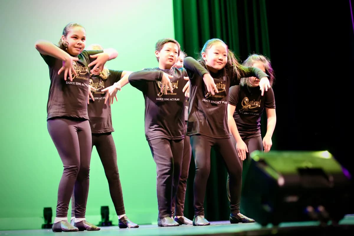 OVATION! hip hop dance class in black OVATION! tees performing under green light in Richmond Hill