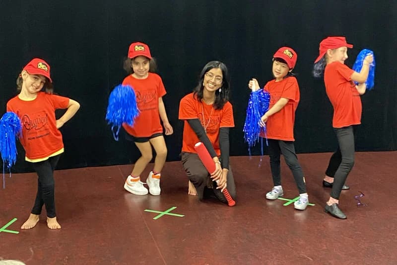 OVATION! creative fun campers in red caps performing with blue pom-poms in Richmond Hill