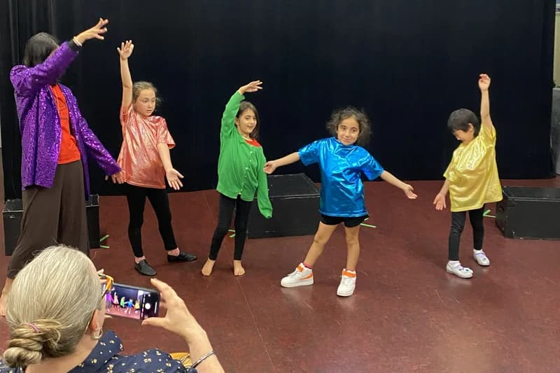 OVATION! creative fun campers in rainbow shirts dancing on stage in Richmond Hill