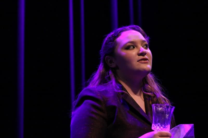 OVATION! senior acting student holding a glass during a scene in the Senior Acting Production in Richmond Hill