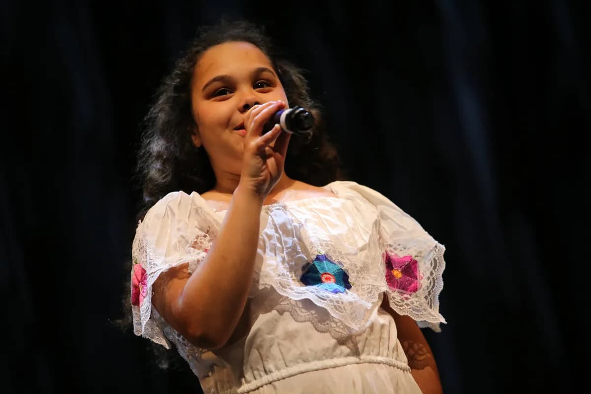 Young OVATION! student singing with a microphone during singing lessons in Richmond Hill