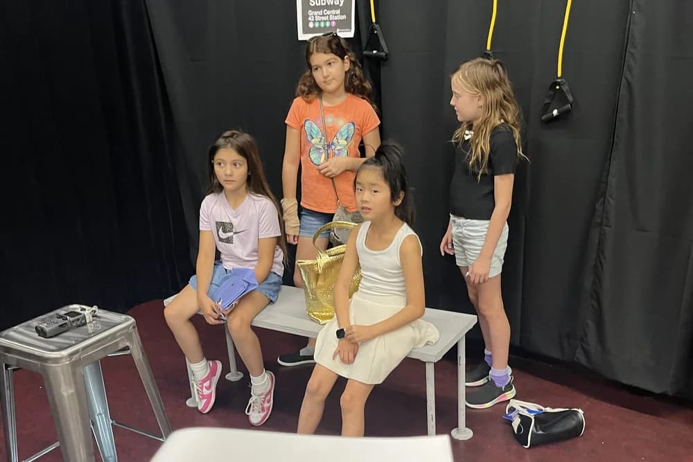 OVATION! summer movie production cast members on a bench set during a Richmond Hill shoot