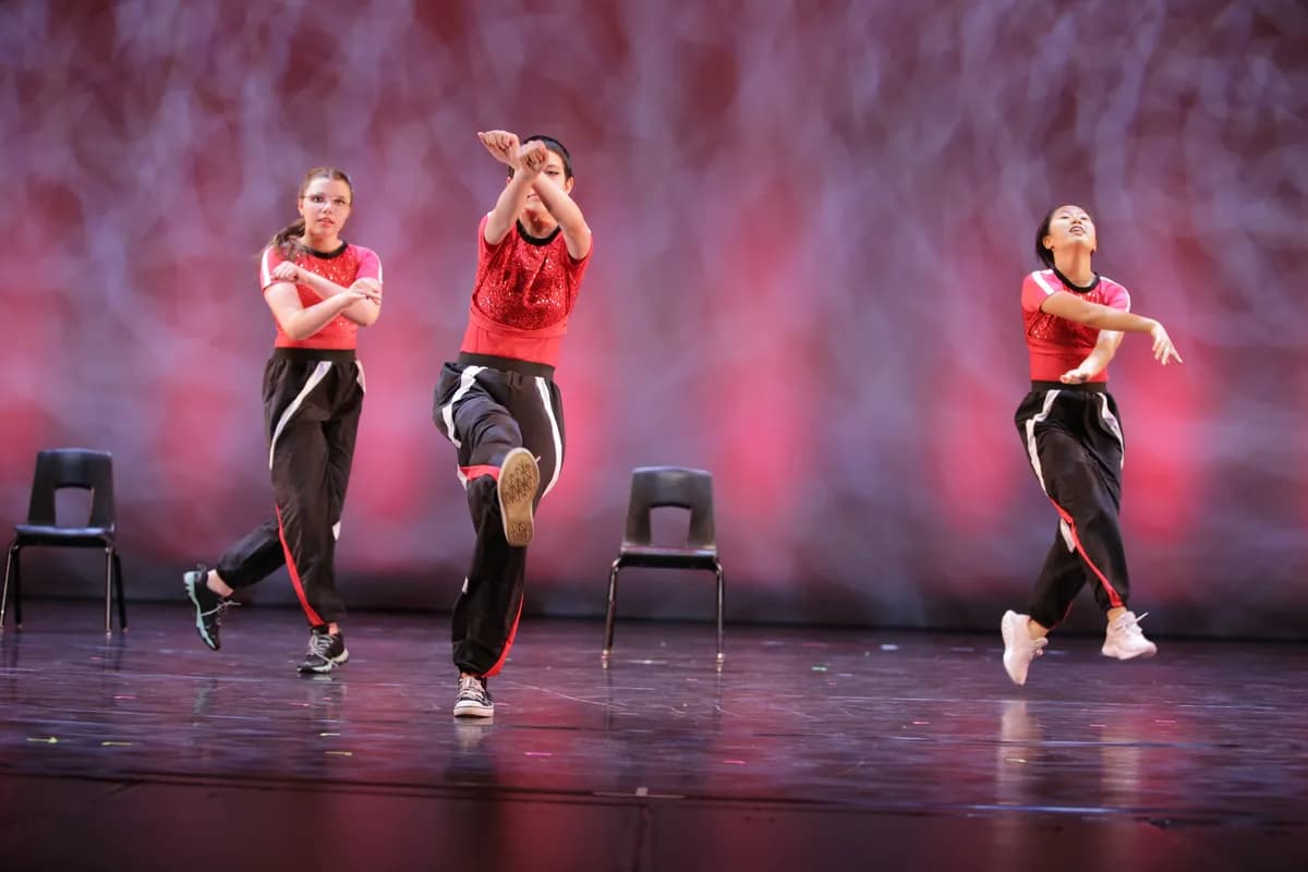 OVATION! teen hip hop dancers in red and black performing with chairs in Richmond Hill