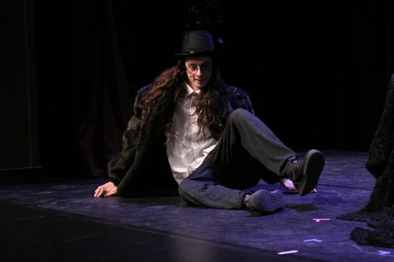 OVATION! student performing in a top hat and fur coat costume for a comedy class