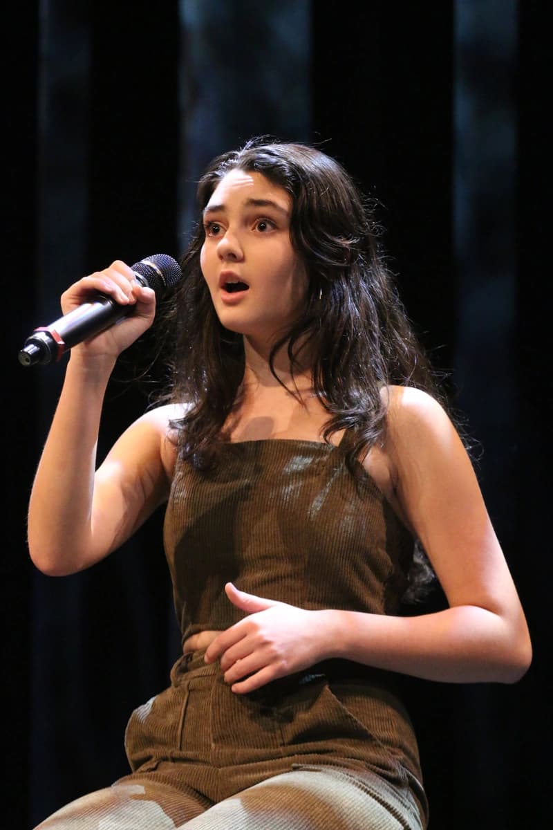 New OVATION! student singing with a microphone on stage in Richmond Hill