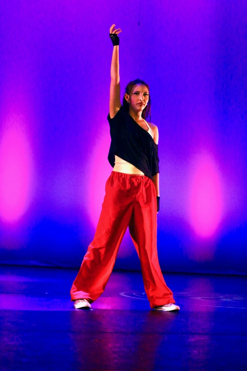 OVATION! dancer performing on stage in a purple spotlight at the Richmond Hill studio showcase