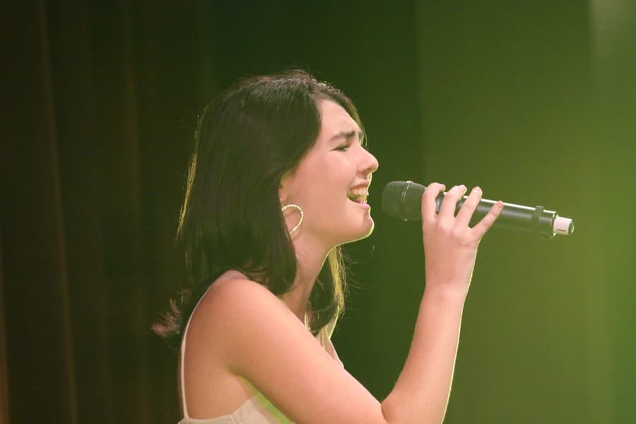 OVATION! student singing on stage at the Richmond Hill performing arts academy showcase