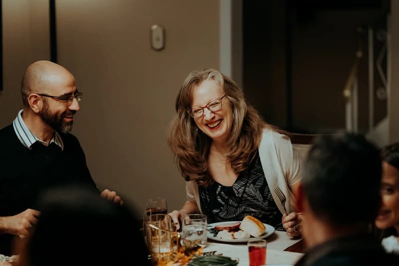 OVATION! adult acting students sharing a laugh in a dinner-table scene