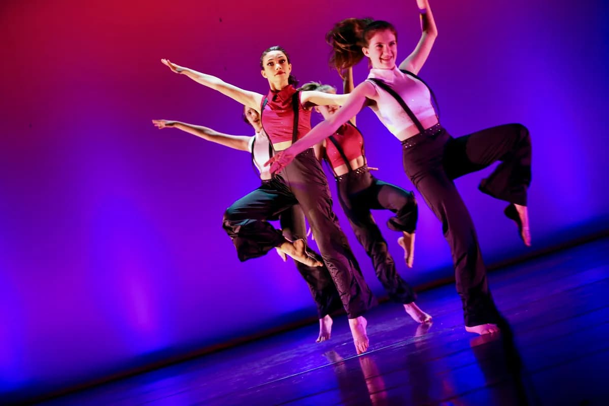 OVATION! ballet dancers in red tops leaping mid-air at a Richmond Hill showcase