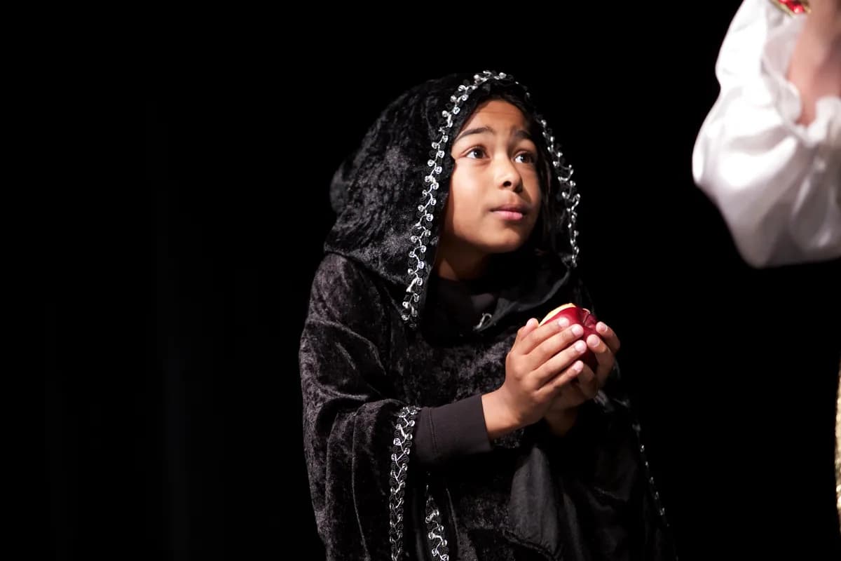 Richmond Hill comedy class performance - OVATION! student in a hooded costume holding an apple