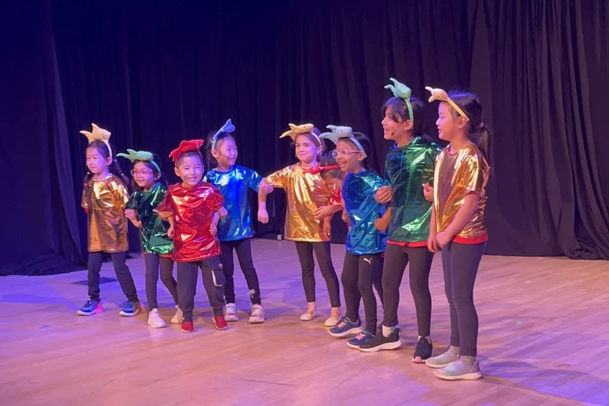 OVATION! Primary students in shiny colourful costumes performing at Get STAGEstruck! Primary in Richmond Hill
