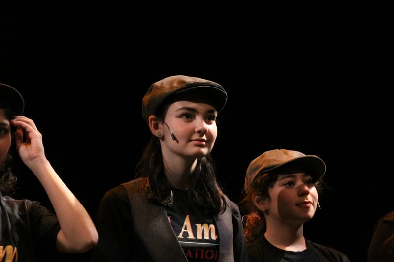OVATION! musical theatre camp performers in newsboy caps on stage during a Richmond Hill show