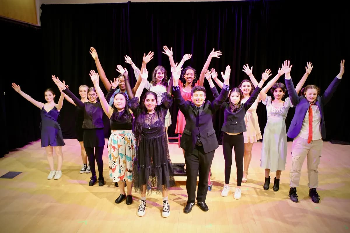 Group of OVATION! musical theatre students with arms raised on stage in Richmond Hill