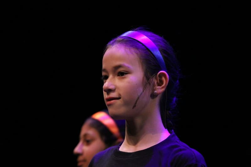 OVATION! summer musical production performer in a headband under stage lights in Richmond Hill