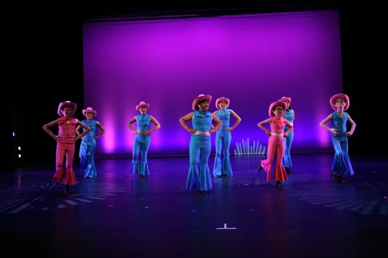 OVATION! tap dance students in cowboy hats and bell-bottom costumes on the Richmond Hill stage