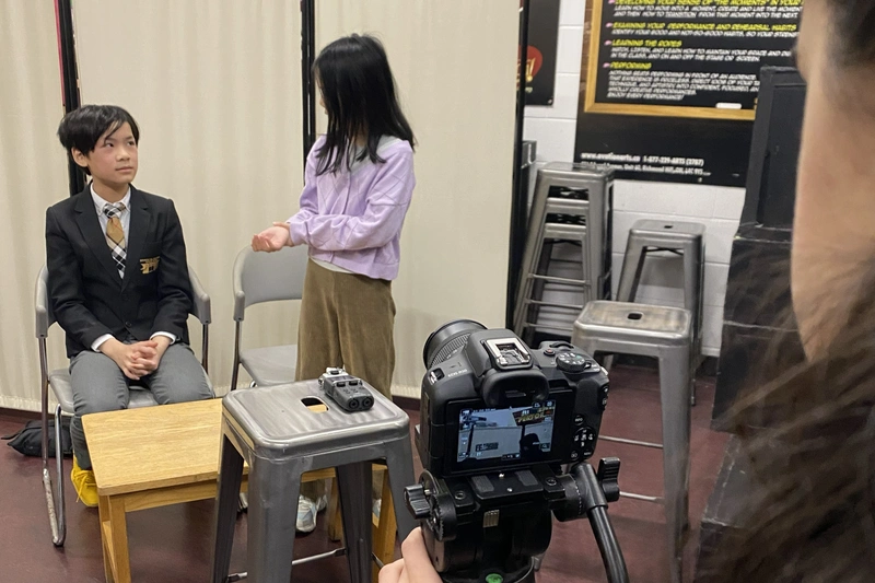 Kids filming a scene with DSLR camera during Richmond Hill summer movie production camp