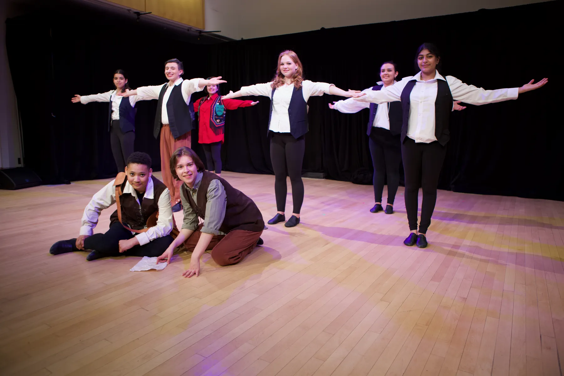 Teen ensemble performing musical theatre